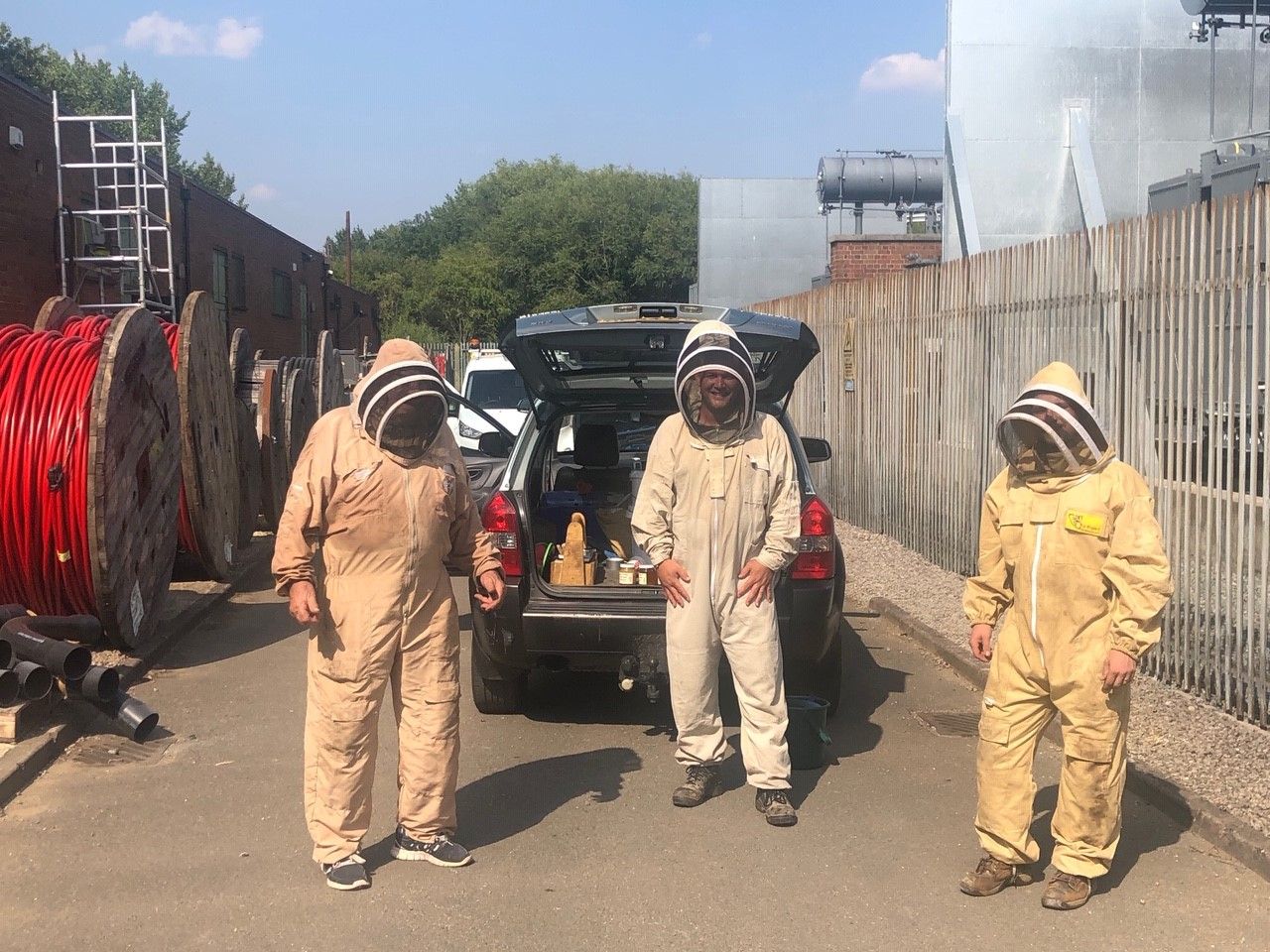 Substation with engineers in beekeeper outfits