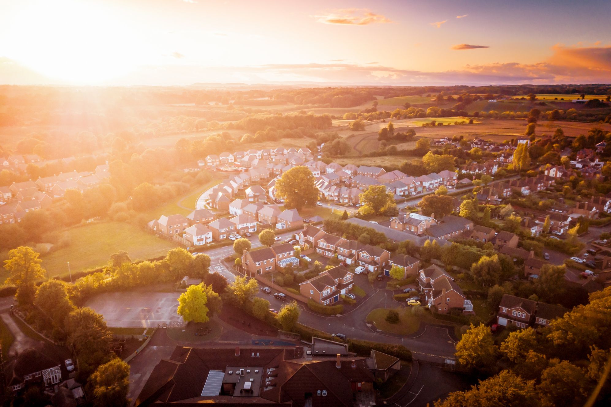 A suburban community at sunset from aerial view
