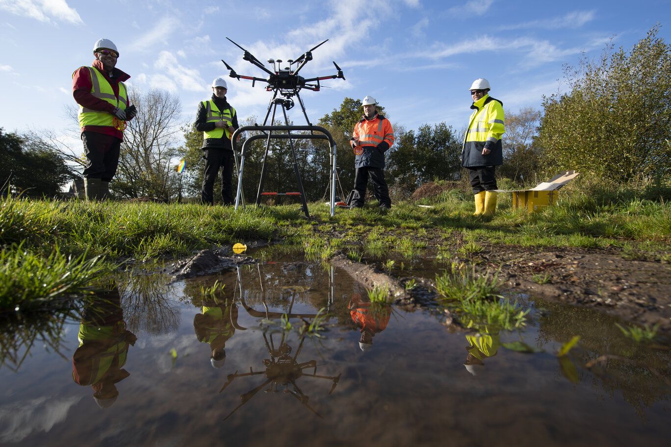 WPD staff standing behind a drone in a field